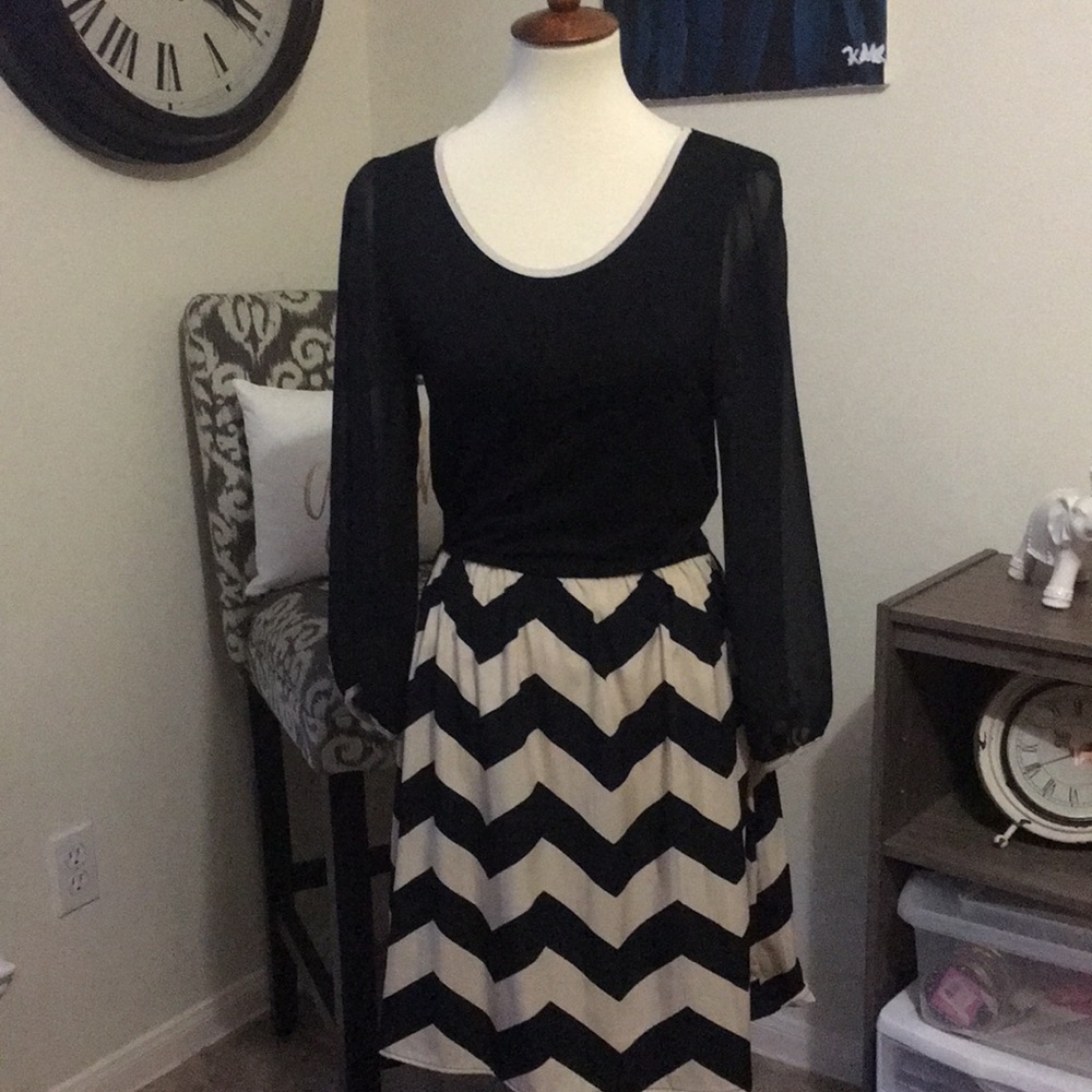 Black dress with chevron skirt and sheer arms